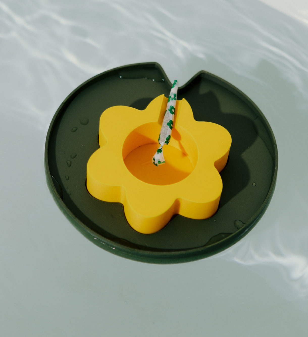 The Yellow Floating Ashtray floating in a bathtub without bubbles