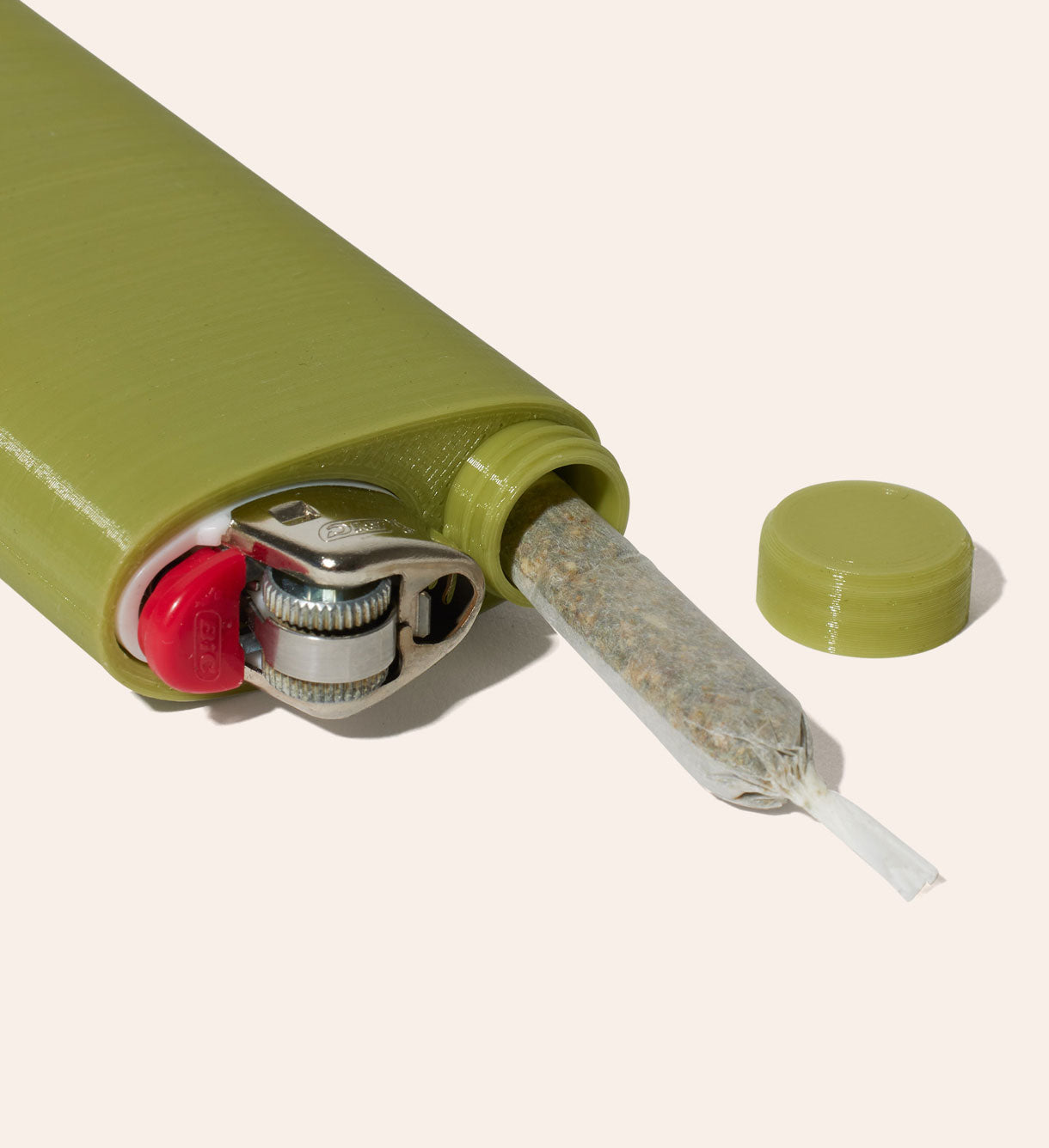 The Green Jointlocker 1.0 with BIC lighter inserted into lighter case, and cap twisted onto protective joint holder