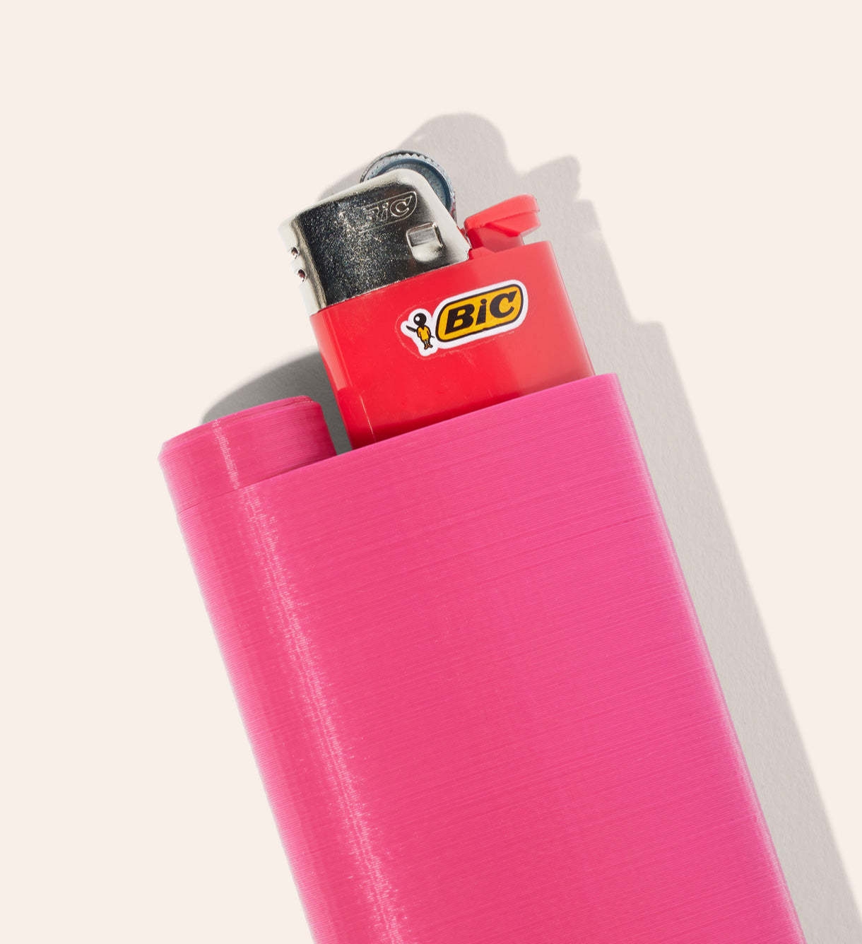 The Magenta Jointlocker 2.0 with BIC lighter coming out of the lighter holder spot and cap twisted onto joint case area